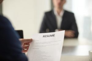 Close up of man holding resume